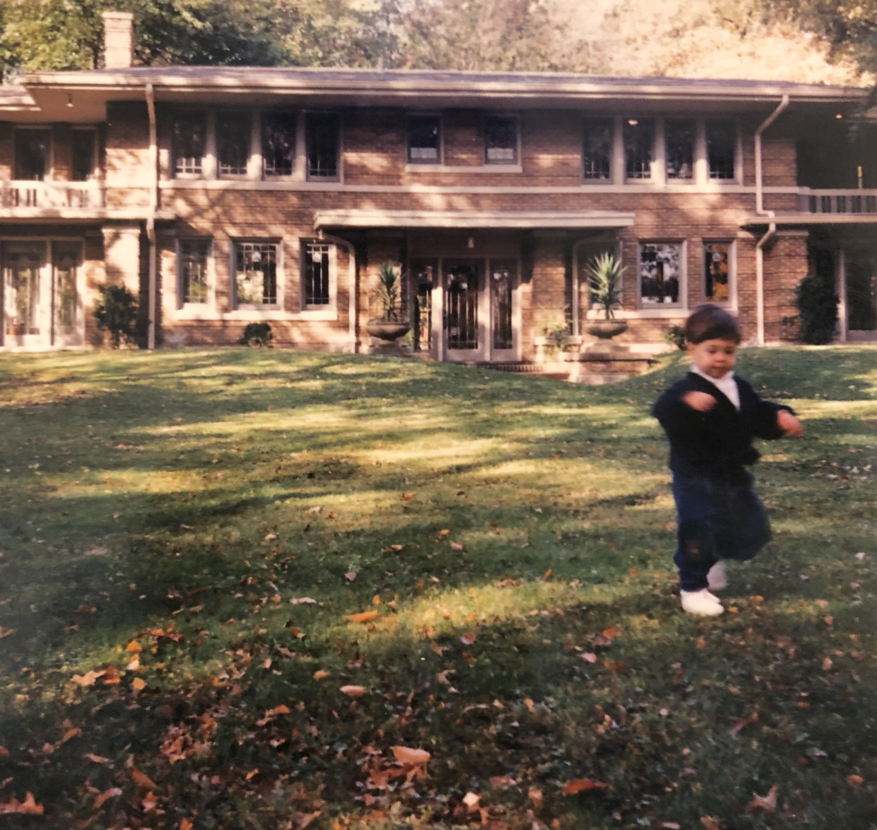 Ian Starnes ’11 in front of one of his childhood homes on Meridian Street in Indianapolis. 