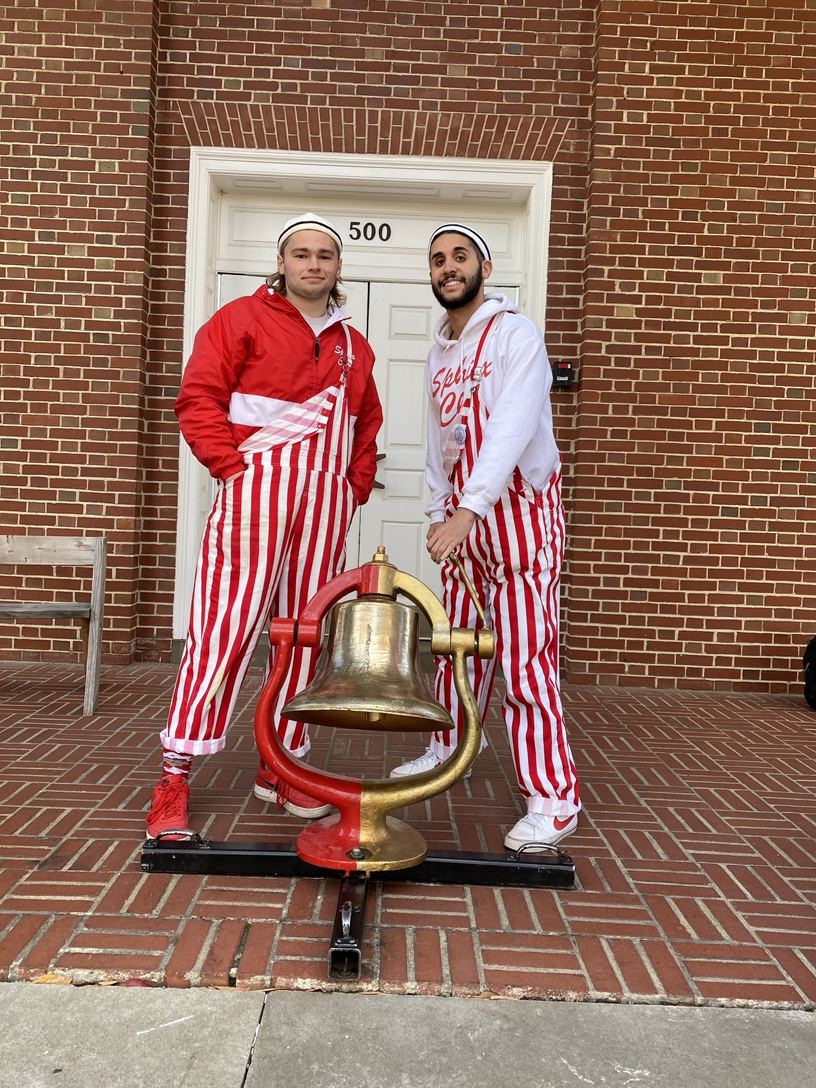 Sphinx Club’s 99th President Andrew Gonczarow ‘22 (left) and 100th President Adam El-Khalili ‘23 (right) stand with the Bell in front of Pioneer Chapel following a Wabash victory in the 127th Monon Bell Classic.