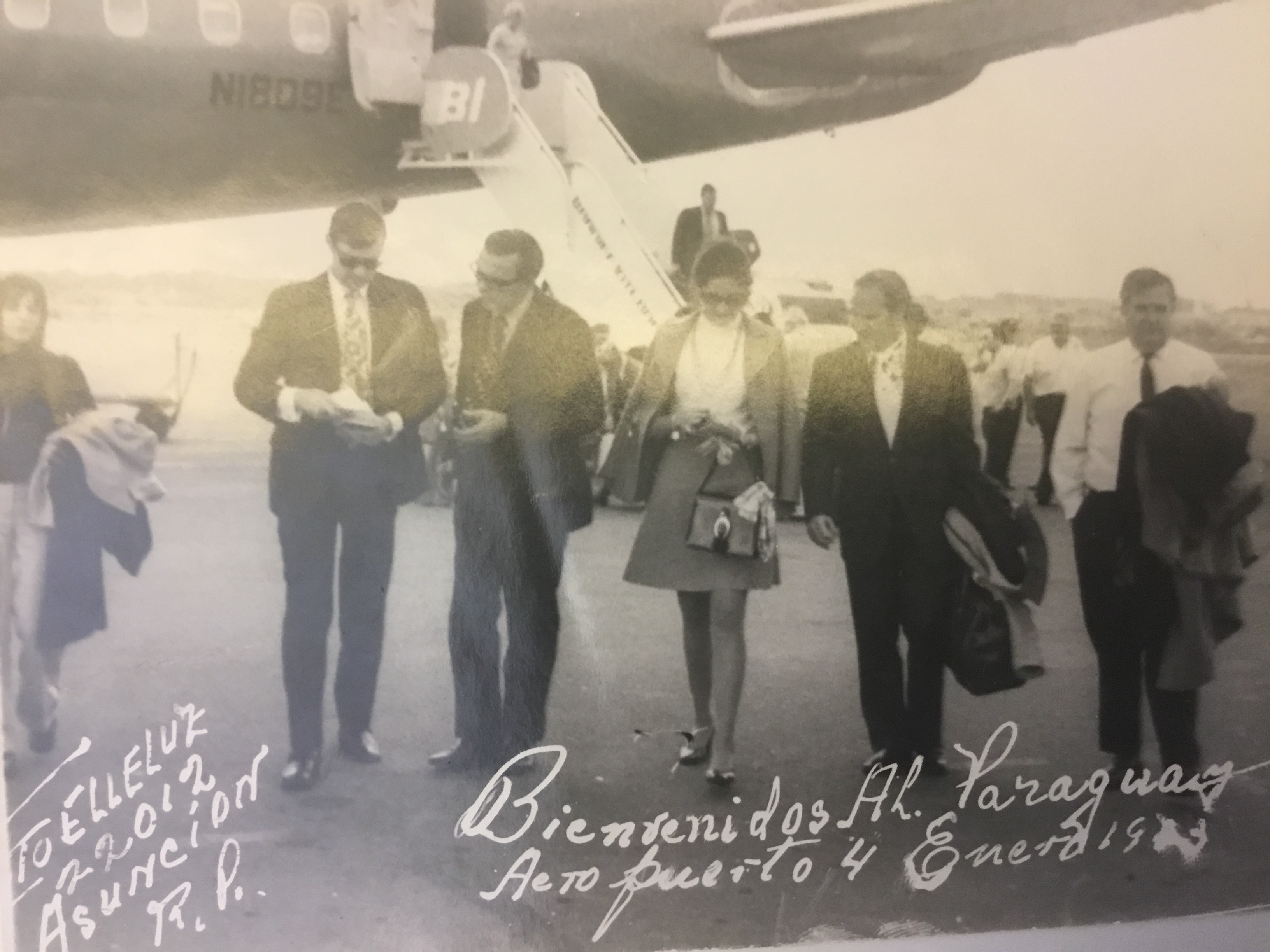 As the Smiths arrive in Asunción, Paraguay, in January 1973, they are met by Embassy personnel. 