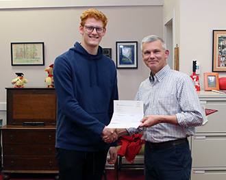 Oostman (left) receives his Realizing the Dream scholarship notification from Dean of Students Greg Redding.